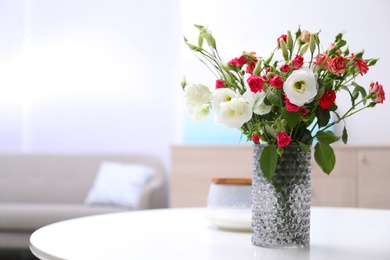 Vase with beautiful flowers on white table in room, space for text Photo of Vase with beautiful flowers on white table in room, space for text