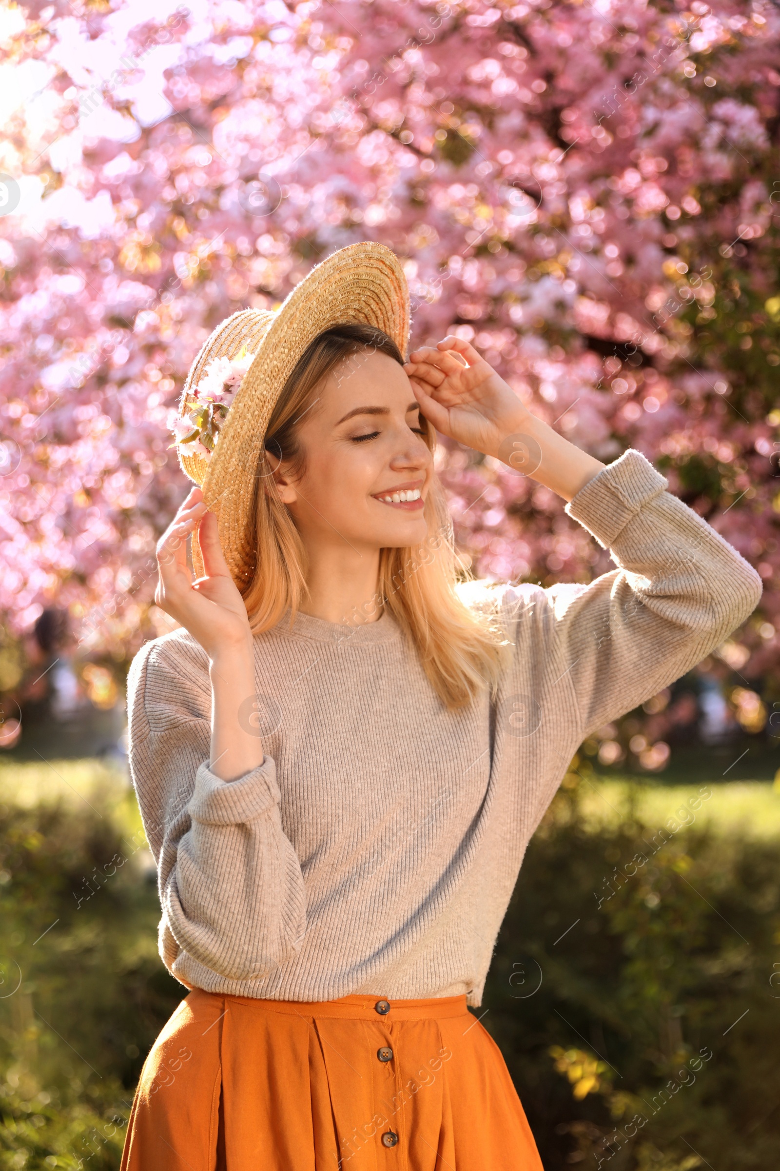 Young woman wearing stylish outfit in park on spring day. Fashionable look Photo of Young woman wearing stylish outfit in park on spring day. Fashionable look
