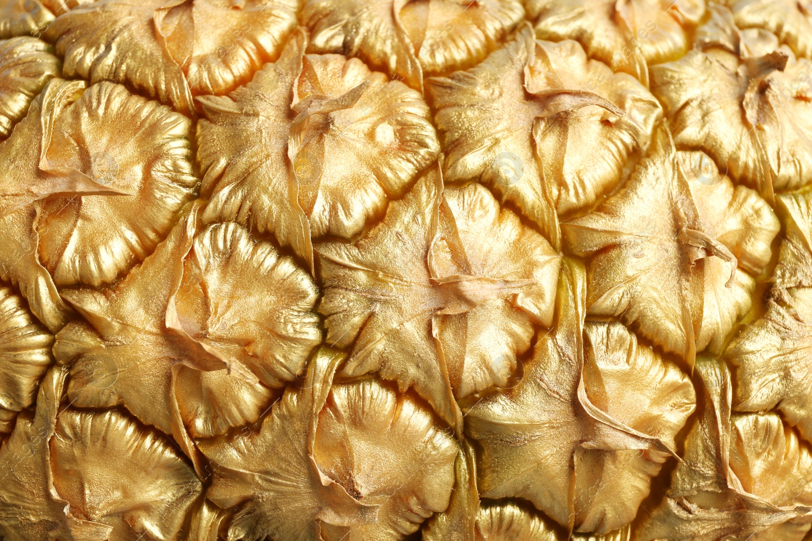 Golden pineapple as background, closeup. Creative concept Photo of Golden pineapple as background, closeup. Creative concept