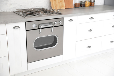 New modern oven in stylish kitchen. Cooking appliance Photo of New modern oven in stylish kitchen. Cooking appliance