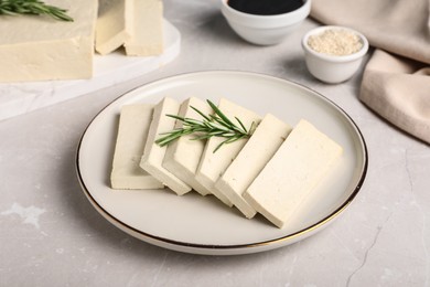 Delicious tofu with rosemary served on light table Photo of Delicious tofu with rosemary served on light table