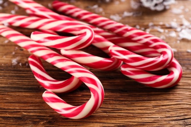 Sweet Christmas candy canes on wooden table, closeup Photo of Sweet Christmas candy canes on wooden table, closeup