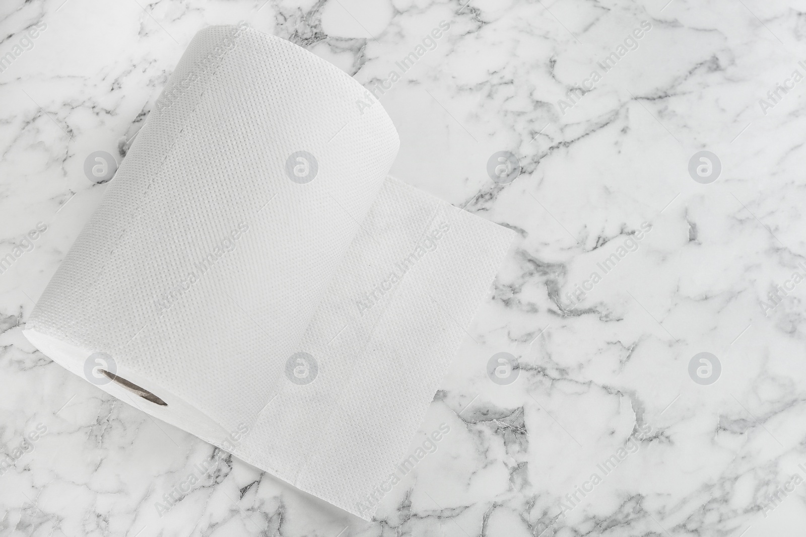 Roll of paper tissues on white marble table, top view. Space for text Photo of Roll of paper tissues on white marble table, top view. Space for text