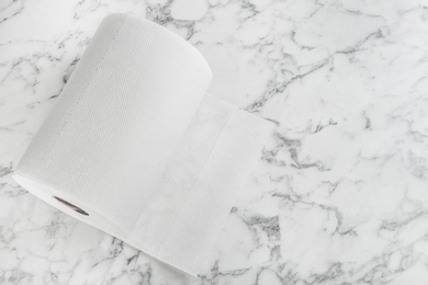 Roll of paper tissues on white marble table, top view. Space for text Photo of Roll of paper tissues on white marble table, top view. Space for text