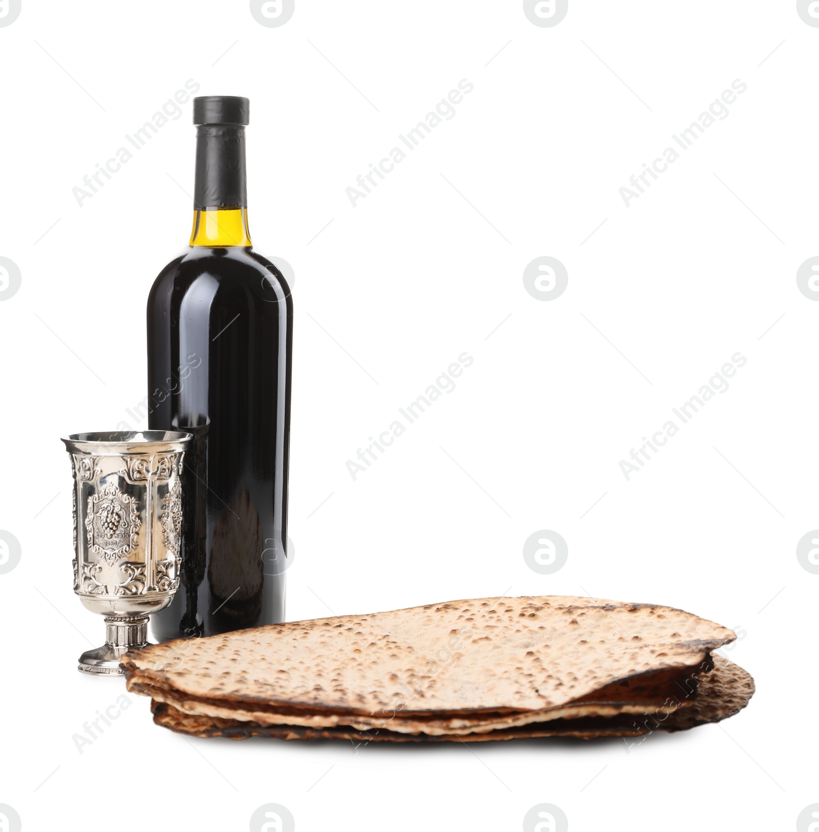 Tasty matzos, wine and goblet on white background. Passover (Pesach) celebration Photo of Tasty matzos, wine and goblet on white background. Passover (Pesach) celebration