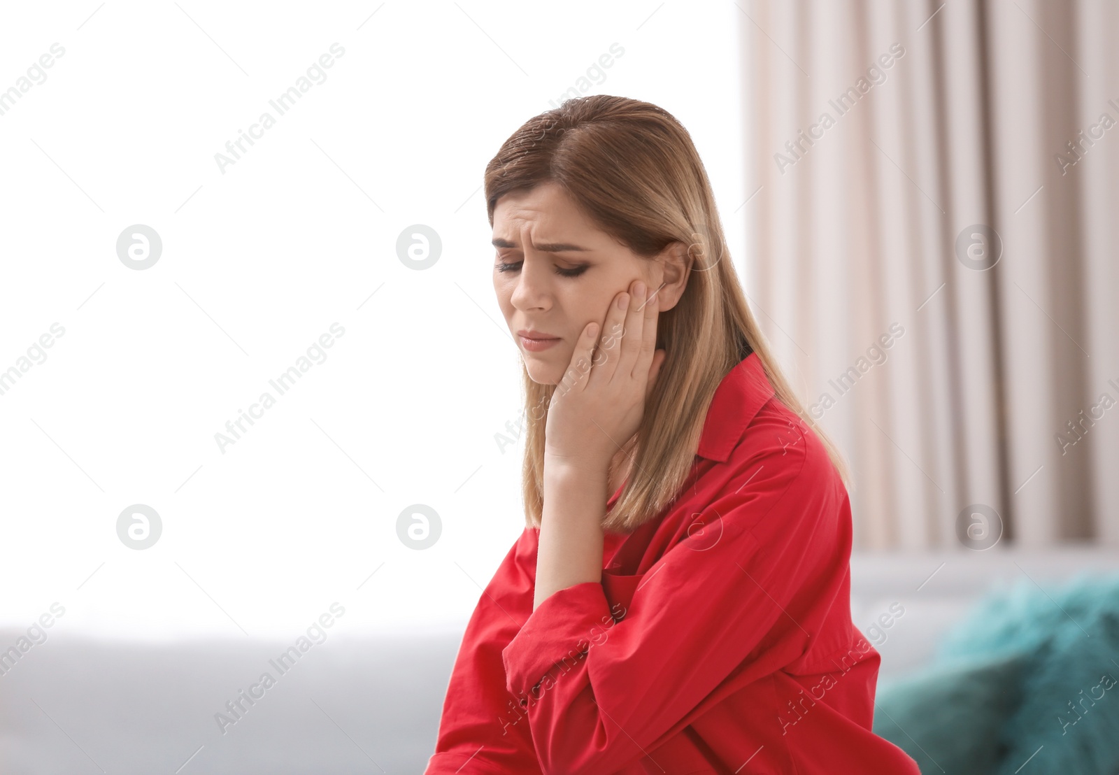 Young woman suffering from toothache at home Photo of Young woman suffering from toothache at home