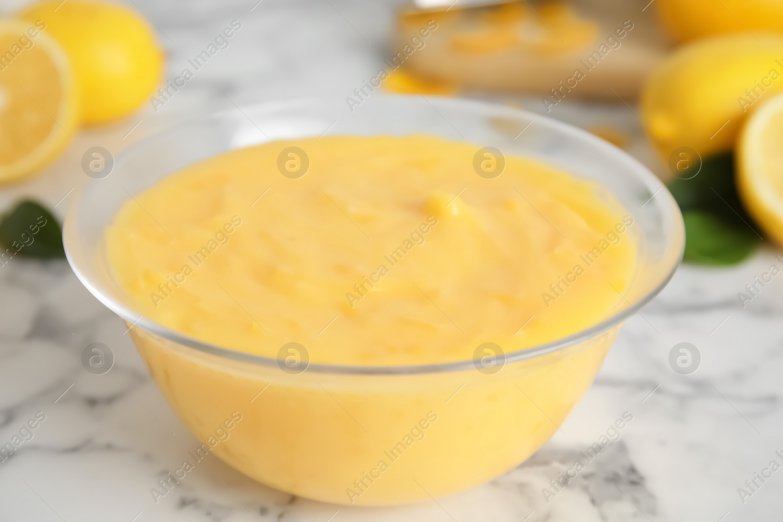 Delicious lemon curd on white marble table, closeup Photo of Delicious lemon curd on white marble table, closeup