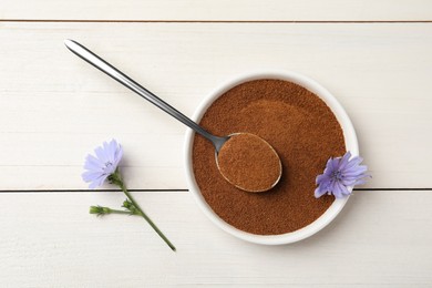 Bowl of chicory powder and flowers on white wooden table, flat lay Photo of Bowl of chicory powder and flowers on white wooden table, flat lay