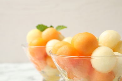 Delicious melon balls and mint in bowl, closeup Photo of Delicious melon balls and mint in bowl, closeup