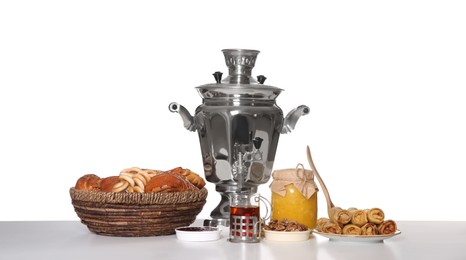 Traditional Russian samovar with treats isolated on white Photo of Traditional Russian samovar with treats isolated on white