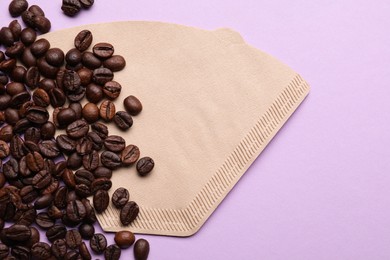 Paper coffee filter and beans on lilac background, flat lay. Space for text Photo of Paper coffee filter and beans on lilac background, flat lay. Space for text