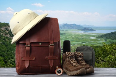 Camping equipment for tourist on wooden surface and beautiful view of mountain landscape Image of Camping equipment for tourist on wooden surface and beautiful view of mountain landscape