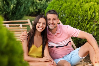 Happy couple resting in deck chairs outdoors Image of Happy couple resting in deck chairs outdoors