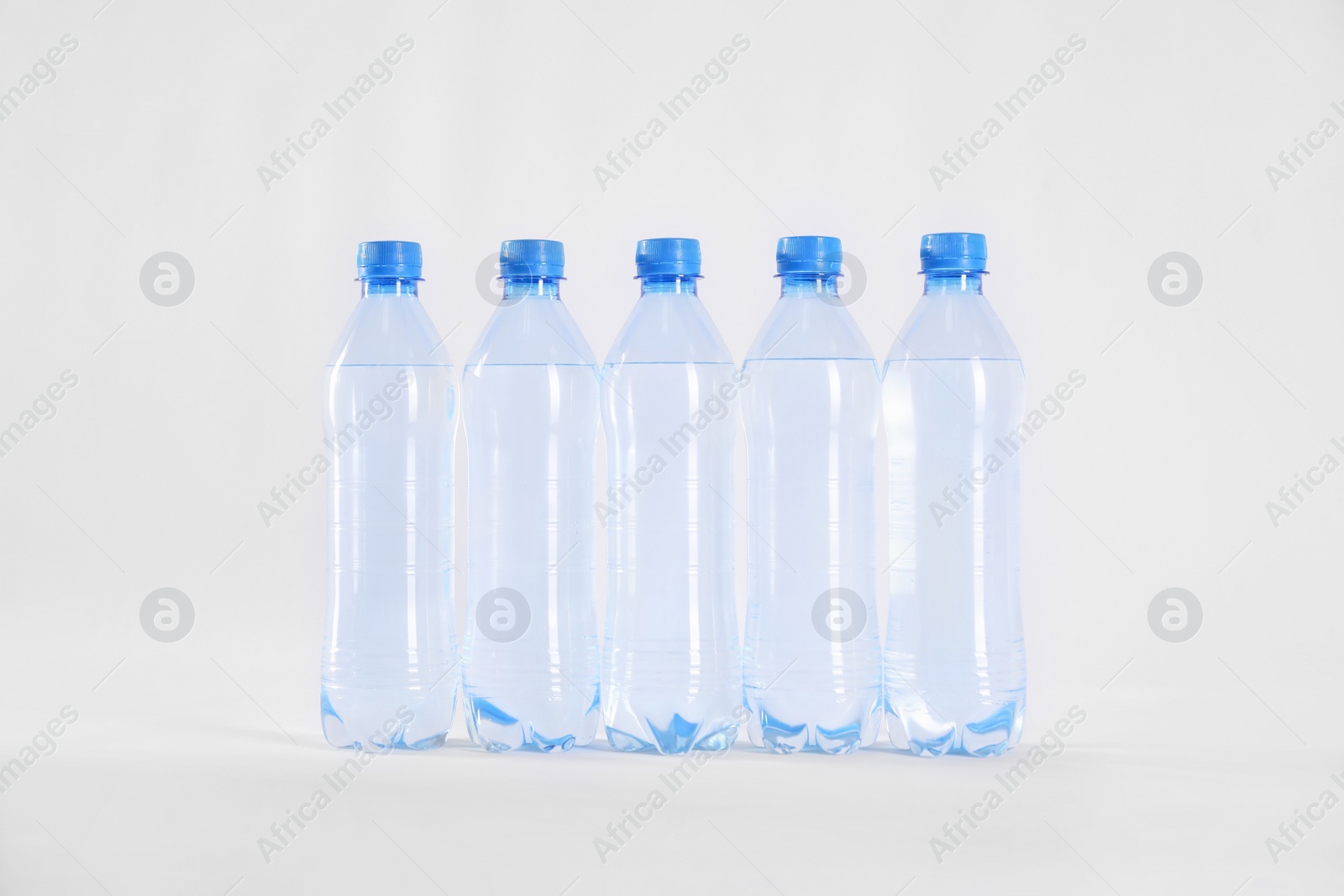 Plastic bottles with pure water on white background Photo of Plastic bottles with pure water on white background