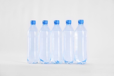 Plastic bottles with pure water on white background Photo of Plastic bottles with pure water on white background
