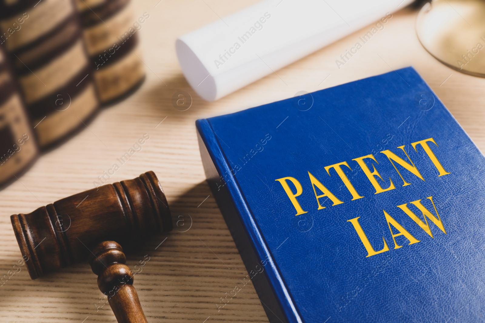 Patent Law book and gavel on wooden table Image of Patent Law book and gavel on wooden table