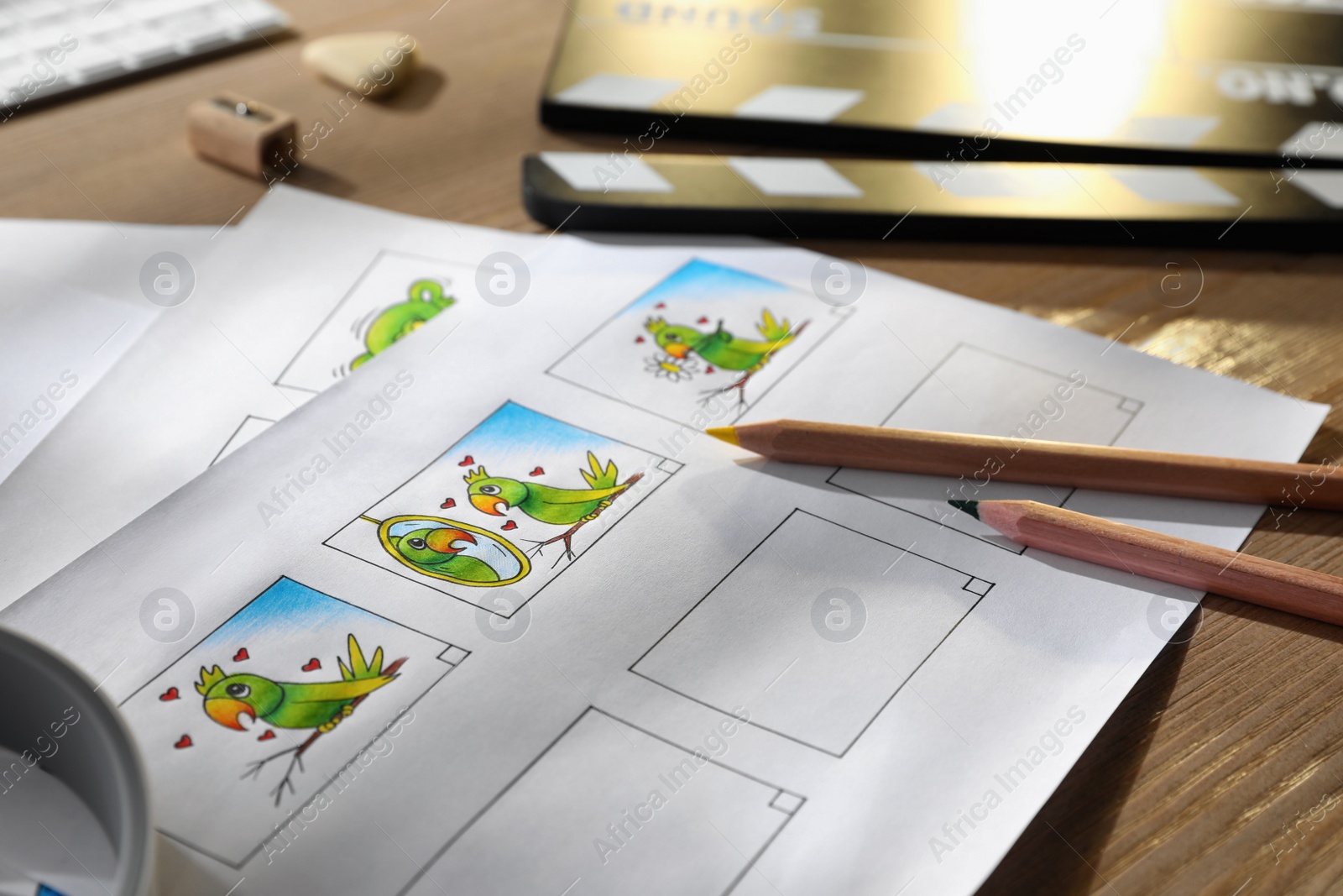 Storyboards with cartoon sketches at workplace, closeup. Pre-production process Photo of Storyboards with cartoon sketches at workplace, closeup. Pre-production process