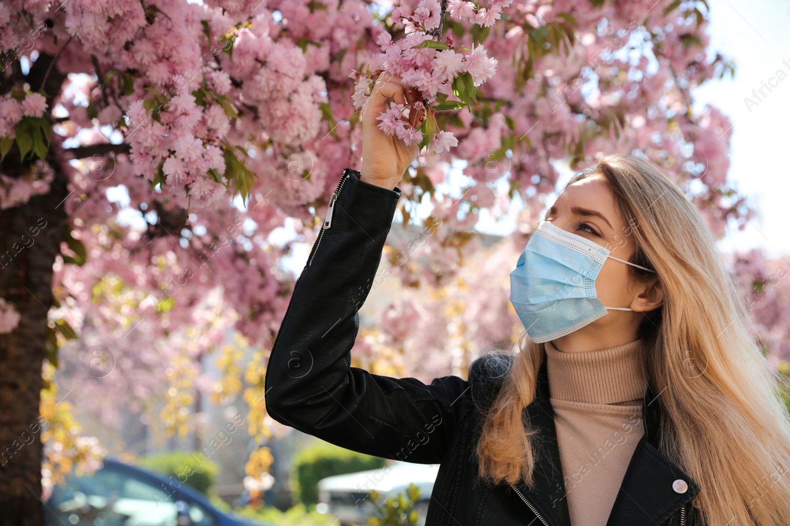 Woman with protective mask near blossoming tree outdoors. Seasonal pollen allergy Photo of Woman with protective mask near blossoming tree outdoors. Seasonal pollen allergy
