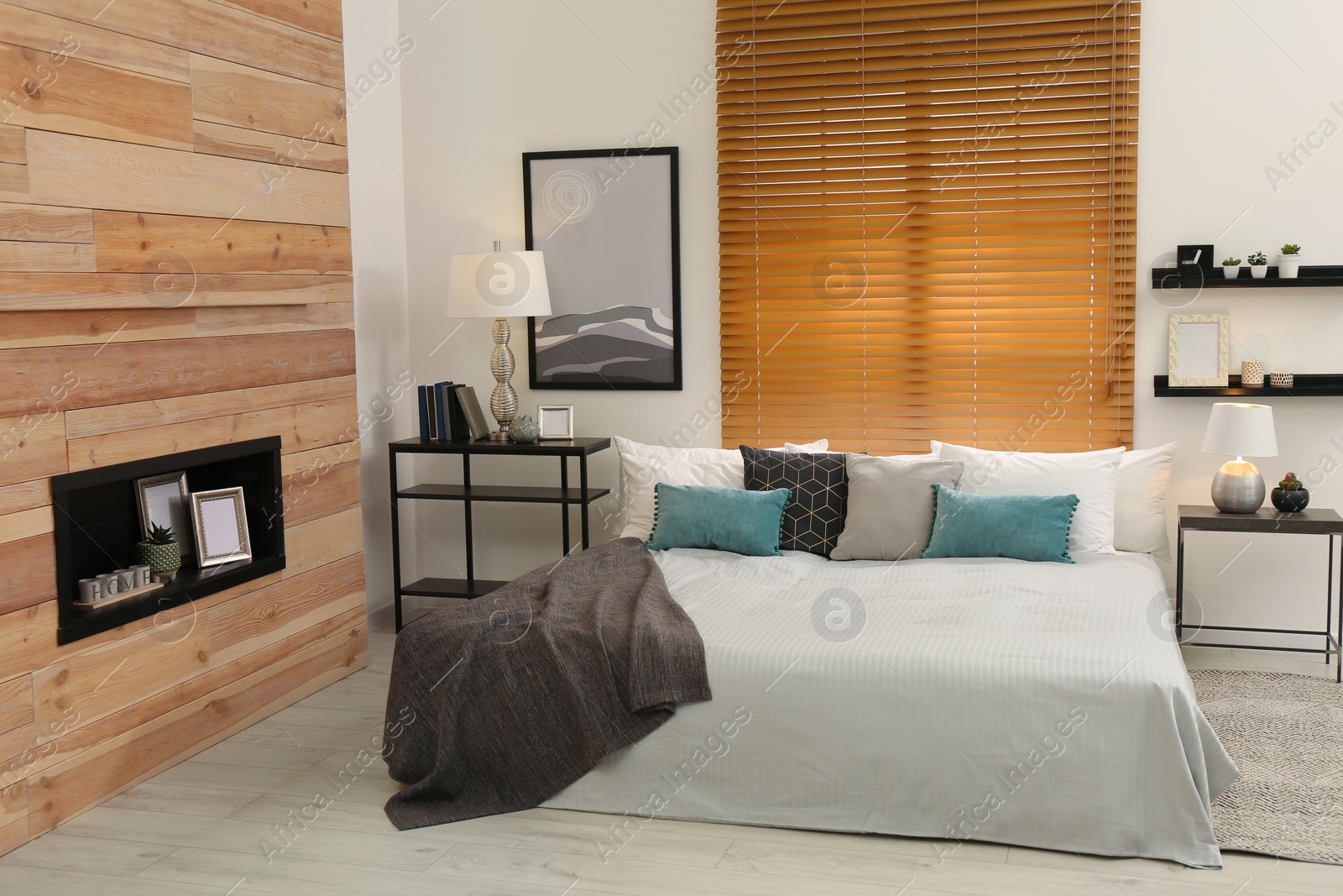 Stylish room interior with big comfortable bed Photo of Stylish room interior with big comfortable bed