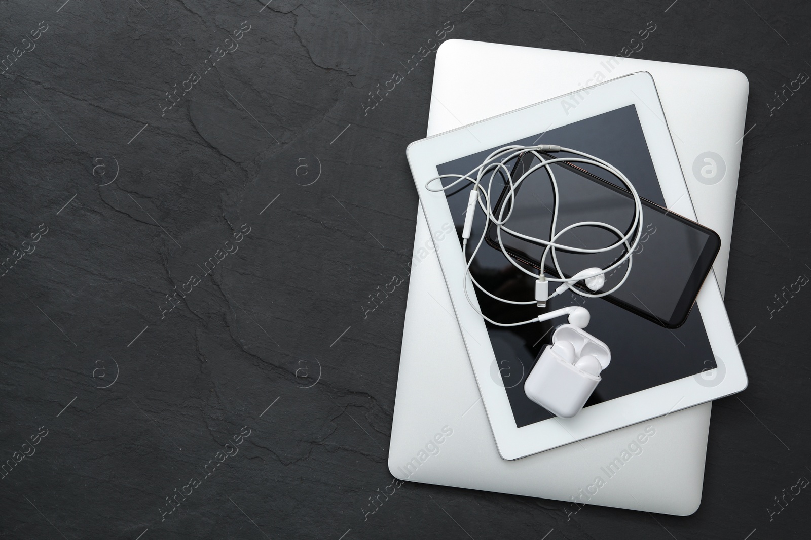 Different gadgets on black stone table, top view with space for text. Digital detox concept Photo of Different gadgets on black stone table, top view with space for text. Digital detox concept