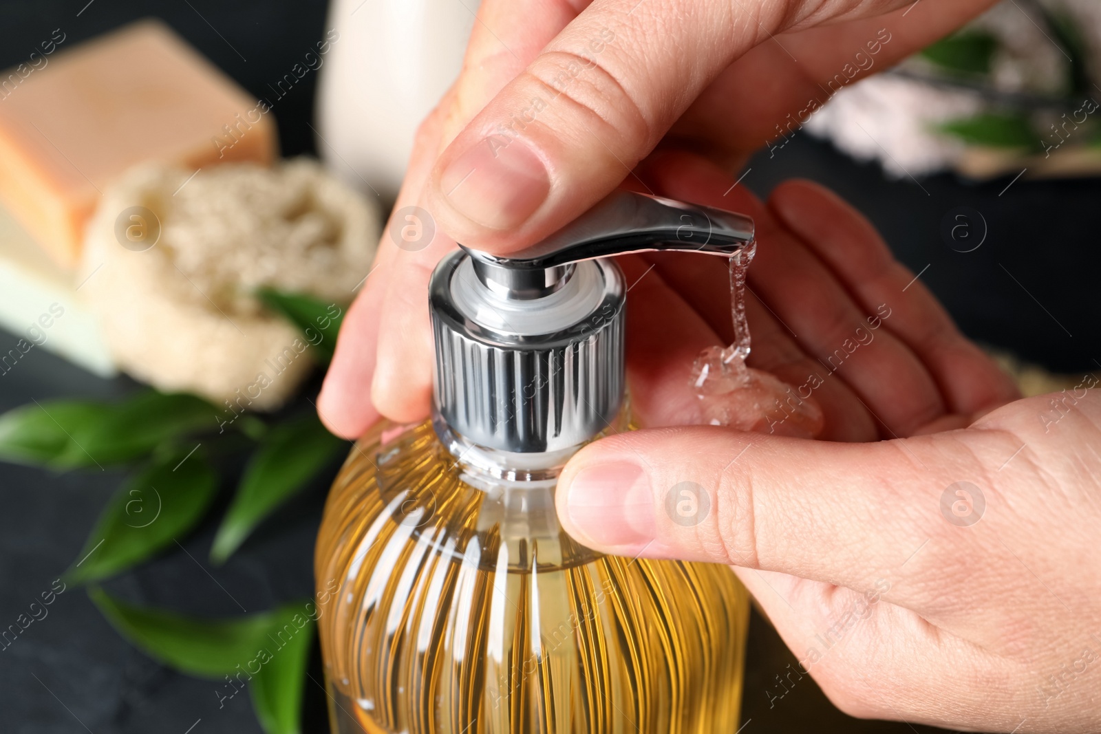 Woman using liquid soap dispenser, closeup view Photo of Woman using liquid soap dispenser, closeup view