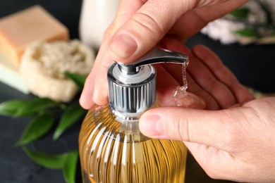 Woman using liquid soap dispenser, closeup view Photo of Woman using liquid soap dispenser, closeup view
