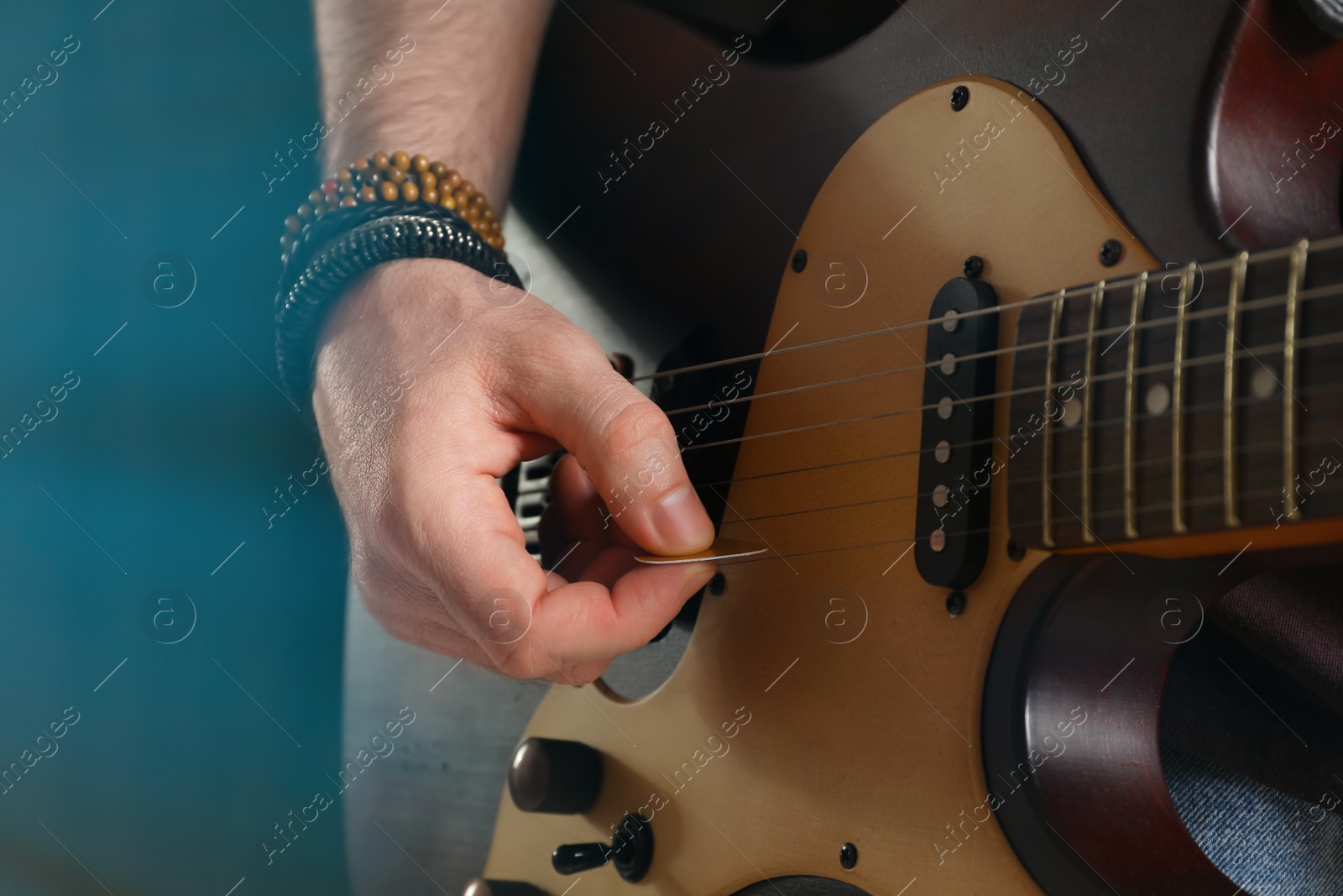 Man playing electric guitar on stage, closeup. Rock concert Photo of Man playing electric guitar on stage, closeup. Rock concert