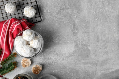 Flat lay composition with Christmas snowball cookies on grey table, space for text Photo of Flat lay composition with Christmas snowball cookies on grey table, space for text